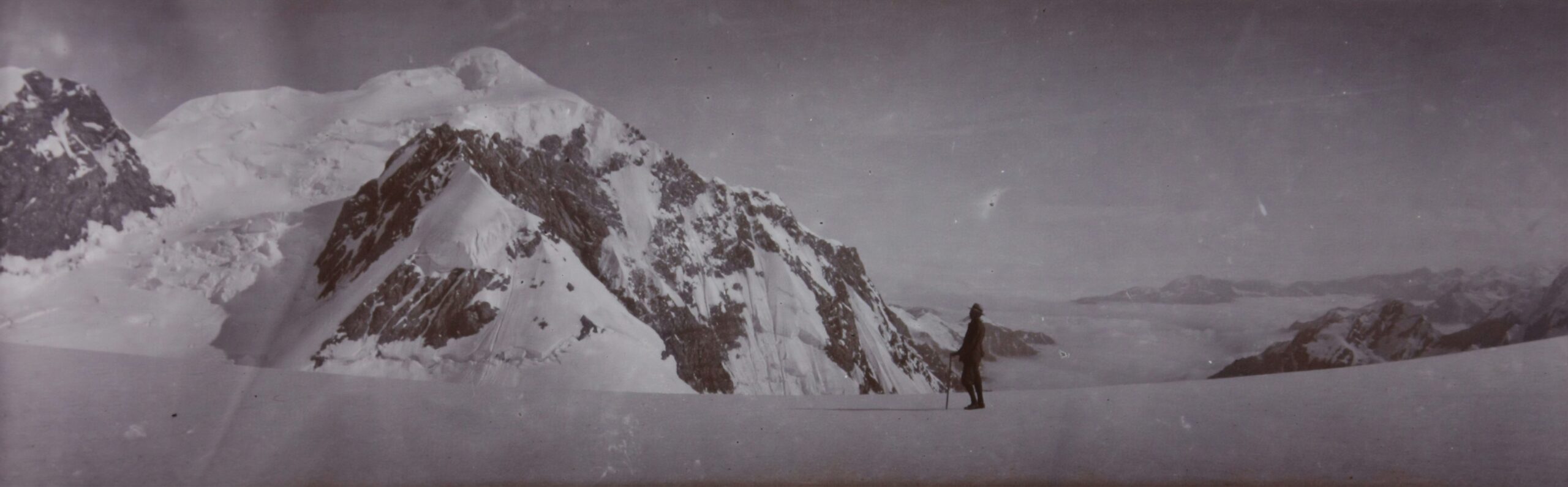 a man standing on top of a snow covered mountain